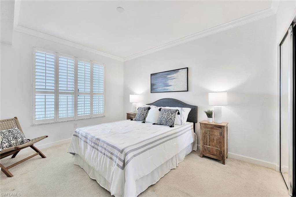 300 Dunes Boulevard, Unit 605 Naples, FL 34110 - Photo 17 of 37 a bedroom with a bed a couch and windows