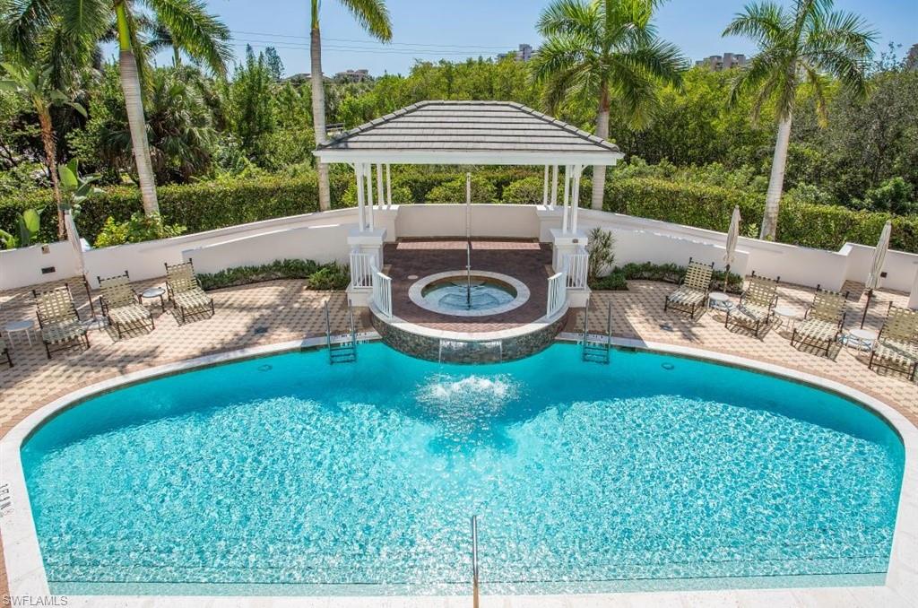 300 Dunes Boulevard, Unit 605 Naples, FL 34110 - Photo 23 of 37 a backyard of a house with yard and outdoor seating