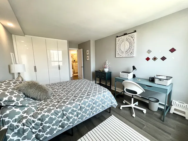 a bedroom with a bed and a table in it