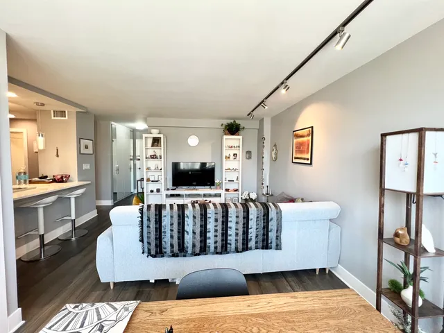 a living room with furniture and a wooden floor
