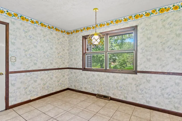 a aerial view of a house with a yard and lake view