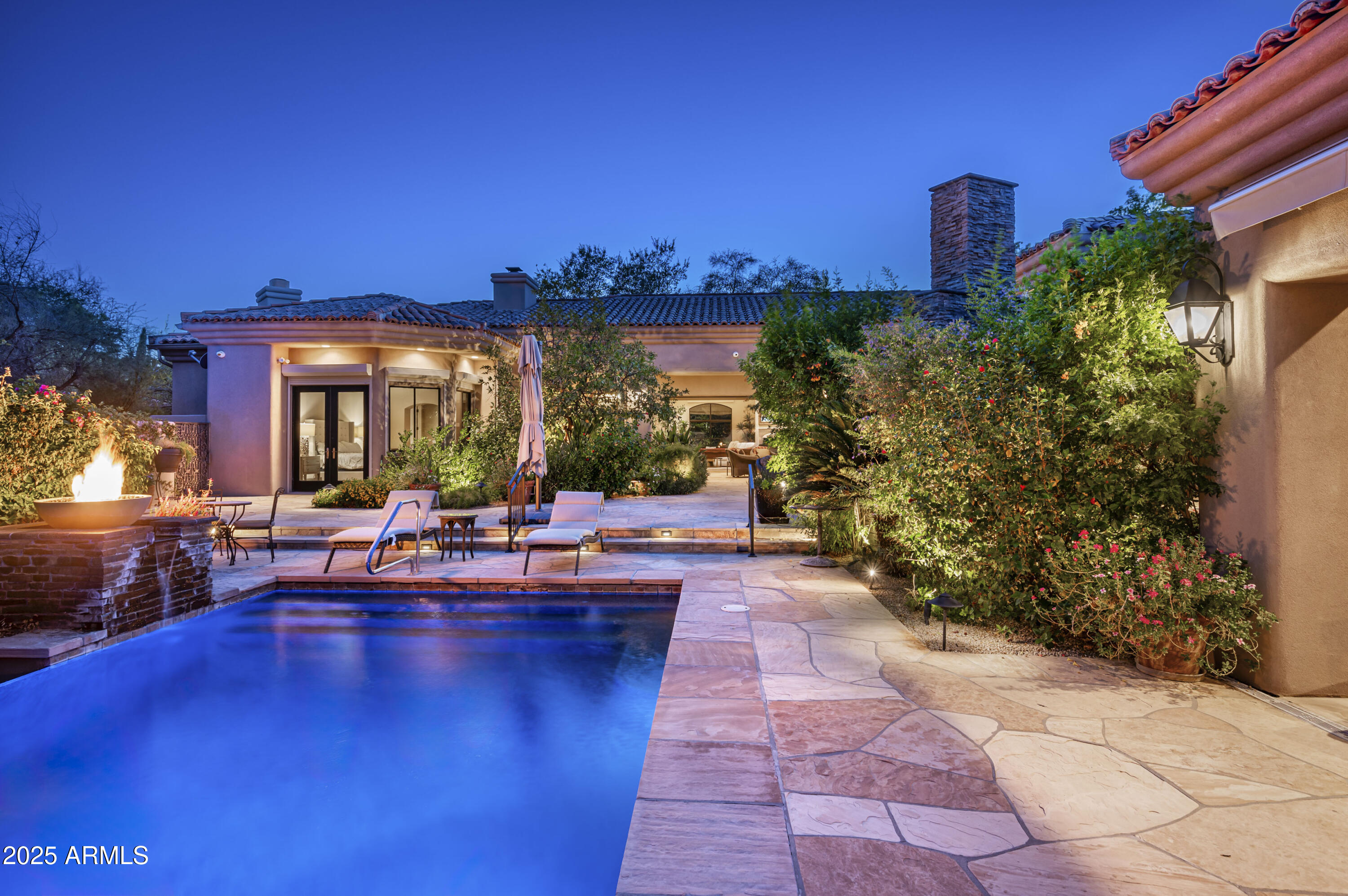 8150 North Ridgeview Drive Paradise Valley, AZ 85253 - Photo 1 of 37 a view of a patio with dining table and chairs with wooden floor and plants