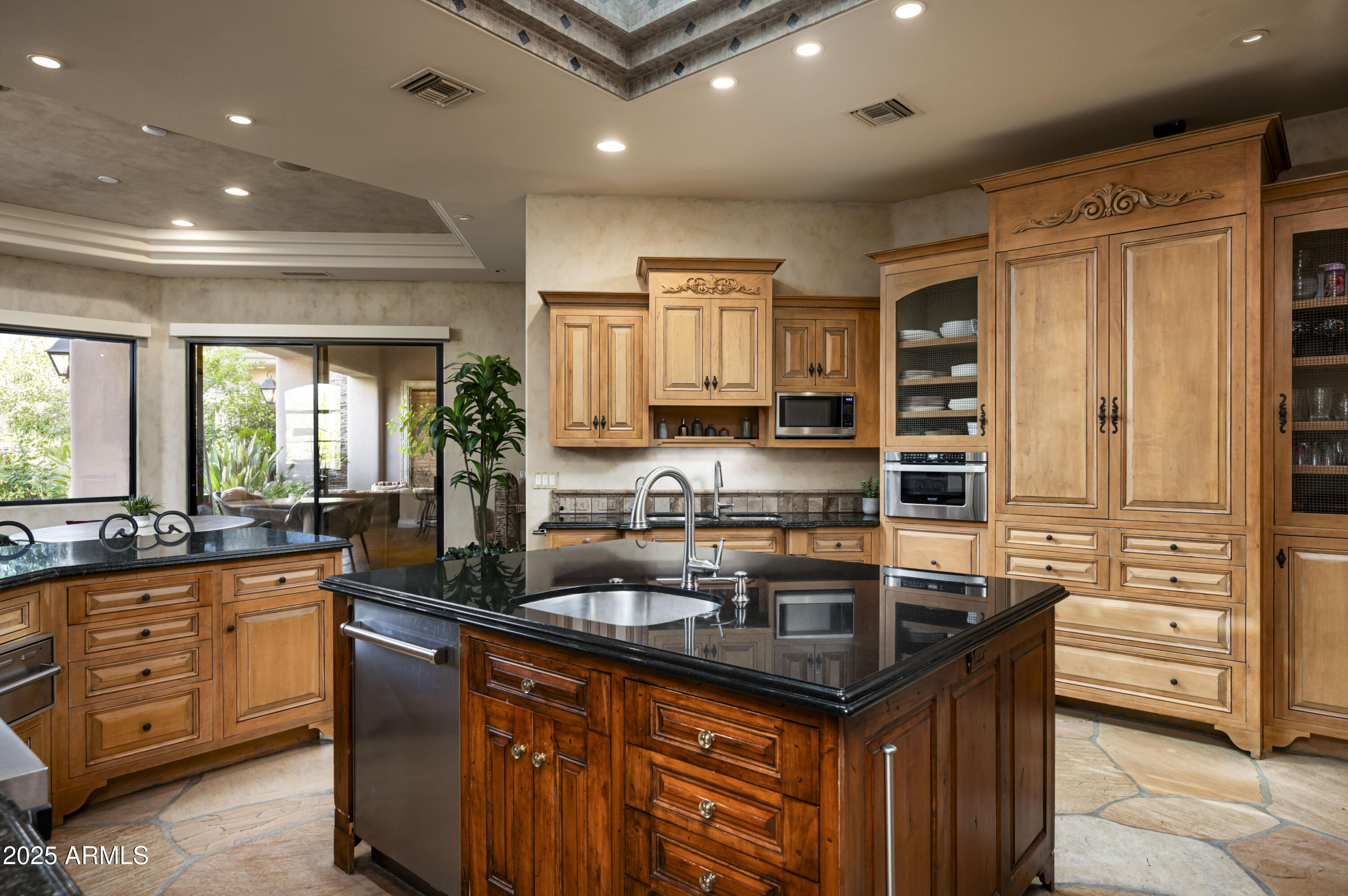 8150 North Ridgeview Drive Paradise Valley, AZ 85253 - Photo 12 of 37 a kitchen with granite countertop a sink stove and cabinets
