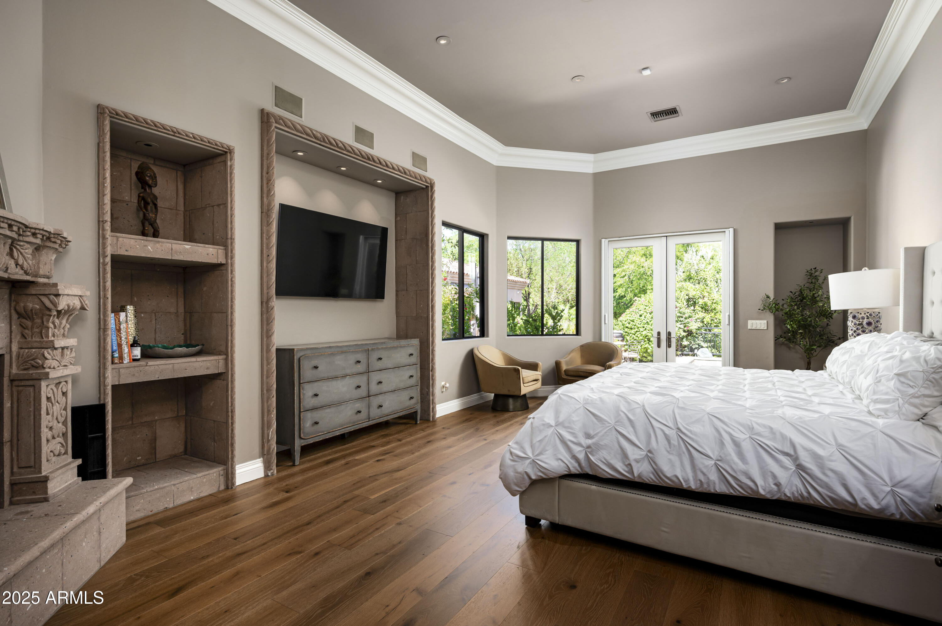 8150 North Ridgeview Drive Paradise Valley, AZ 85253 - Photo 16 of 37 a bedroom with a large bed and a flat tv screen on dresser