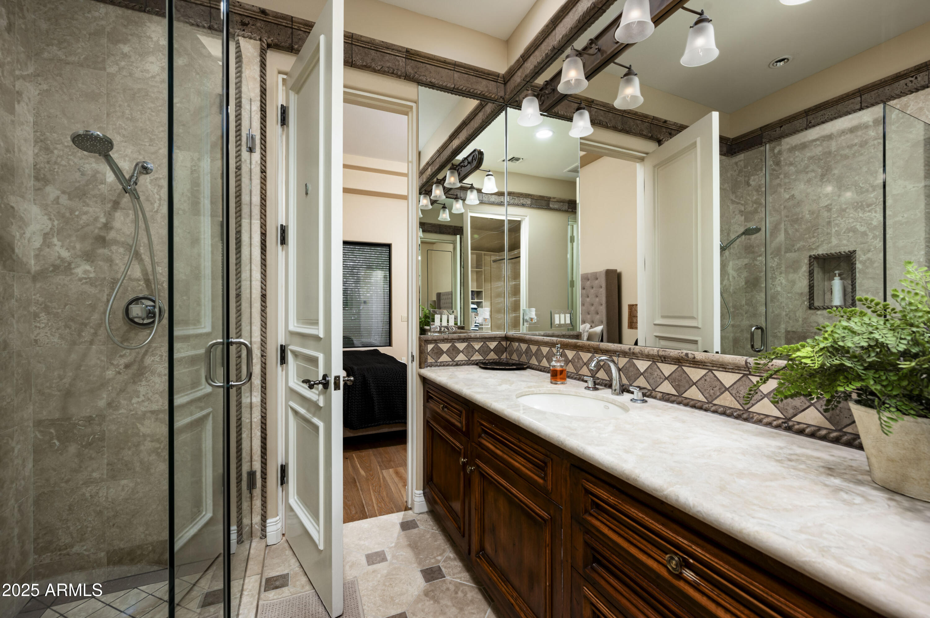 8150 North Ridgeview Drive Paradise Valley, AZ 85253 - Photo 27 of 37 a bathroom with a granite countertop sink a mirror and shower