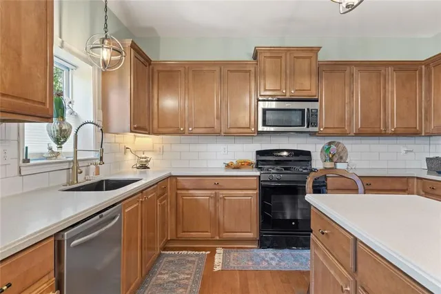 a kitchen with a sink stove and microwave
