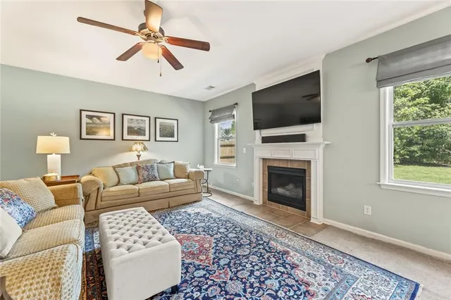 a living room with furniture a flat screen tv and a fireplace