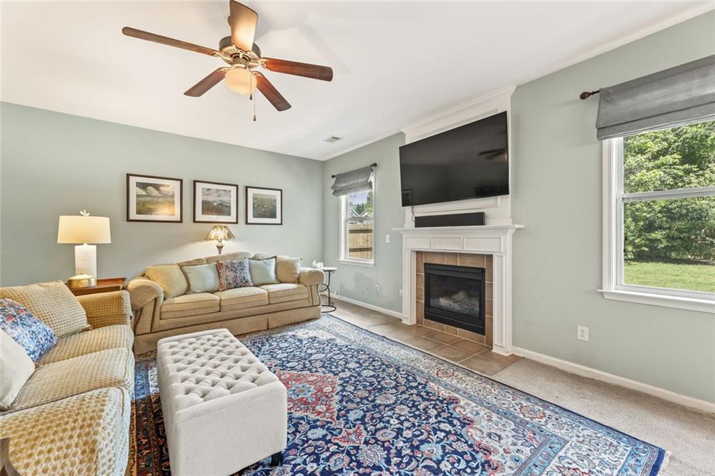 5415 Fieldfreen Drive Cumming, GA 30028 - Photo 18 of 40 a living room with furniture a flat screen tv and a fireplace