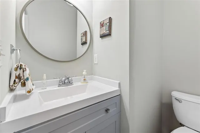 a bathroom with a sink mirror and toilet