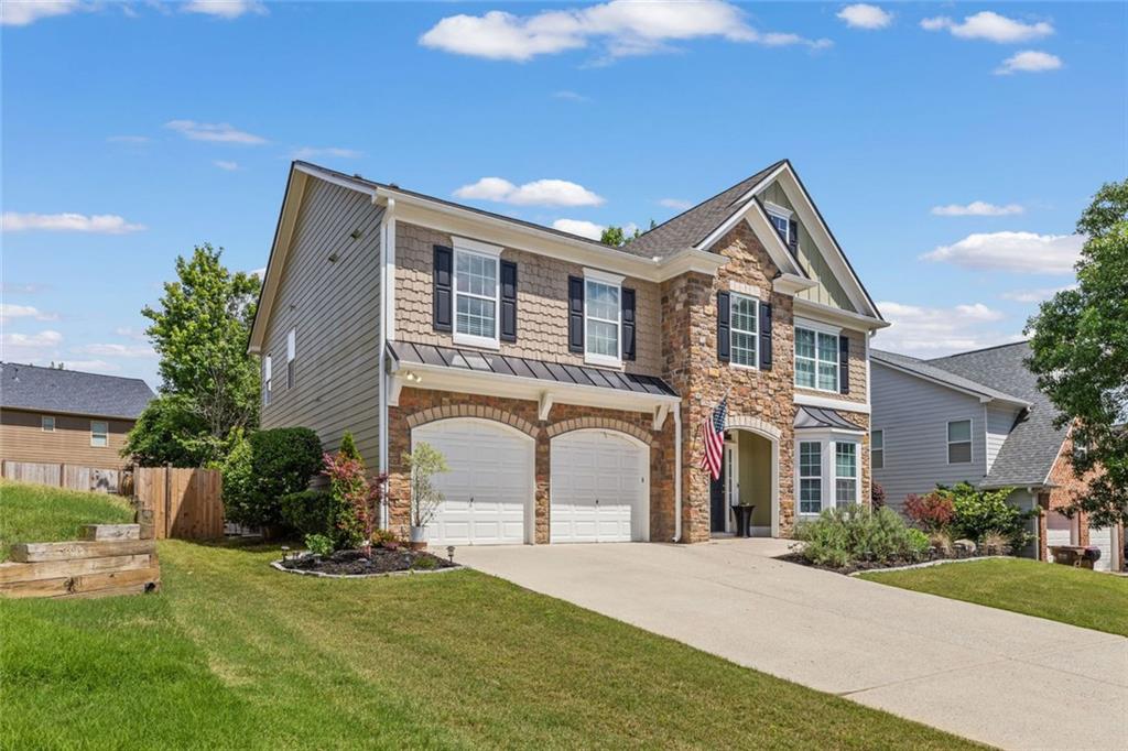 5415 Fieldfreen Drive Cumming, GA 30028 - Photo 2 of 40 a front view of a house with a garden and yard