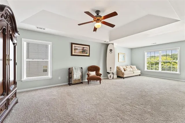 a living room with furniture a window and a flat screen tv