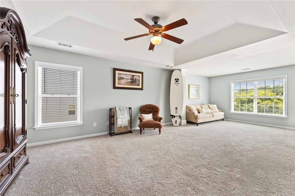 5415 Fieldfreen Drive Cumming, GA 30028 - Photo 29 of 40 a living room with furniture a window and a flat screen tv