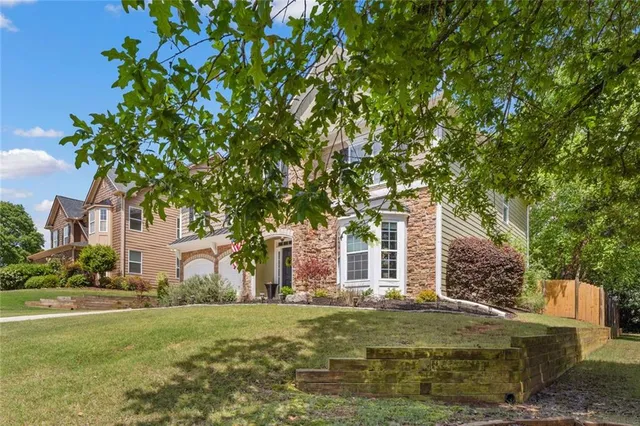 a front view of a house with garden