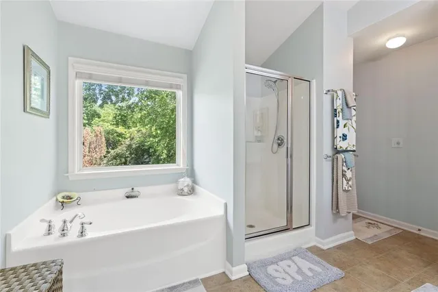 a bathroom with a bathtub and a shower