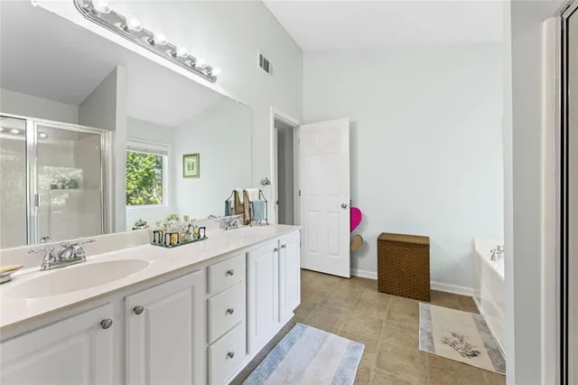 a bathroom with a sink vanity and mirror