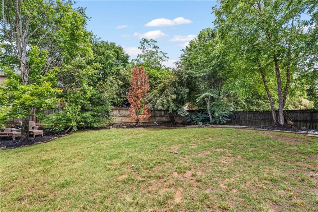 5415 Fieldfreen Drive Cumming, GA 30028 - Photo 38 of 40 a backyard of a house with lots of green space