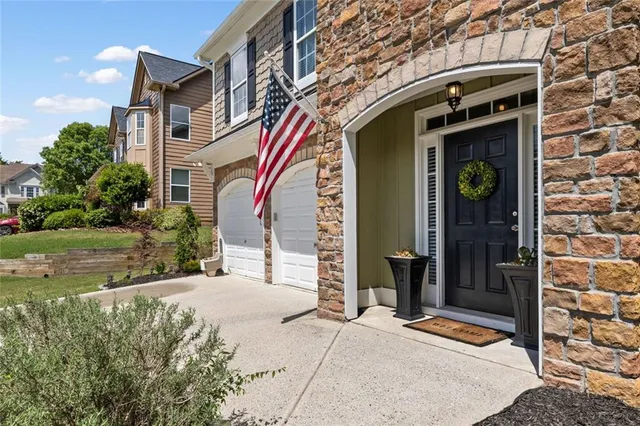 a front view of a building with a garden