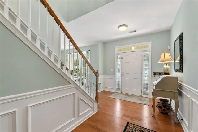 a view of entryway and hall with wooden floor