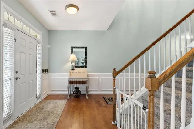 a view of a livingroom with wooden floor and stairs