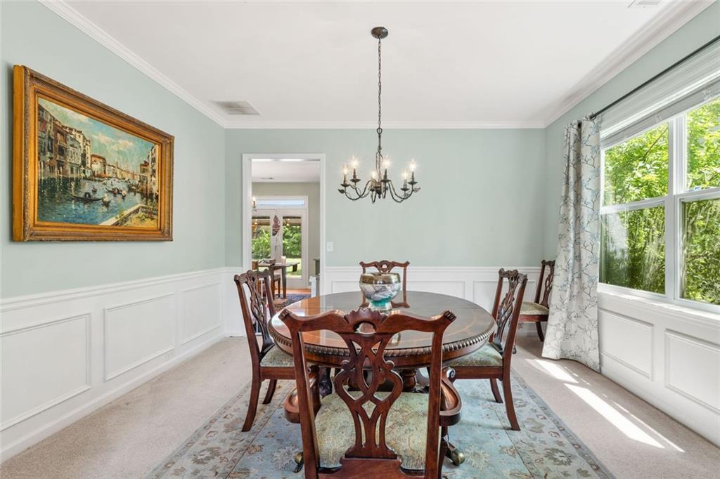 5415 Fieldfreen Drive Cumming, GA 30028 - Photo 9 of 40 a view of a dining room with furniture a chandelier and wooden floor