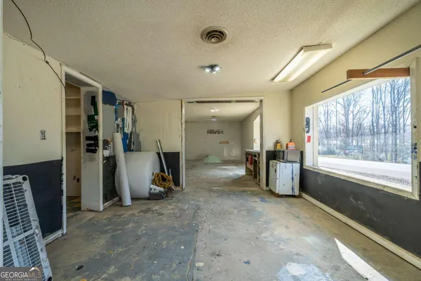 a view of a big room with windows and cabinet