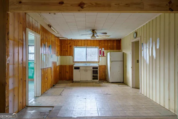 a kitchen with a refrigerator and a stove