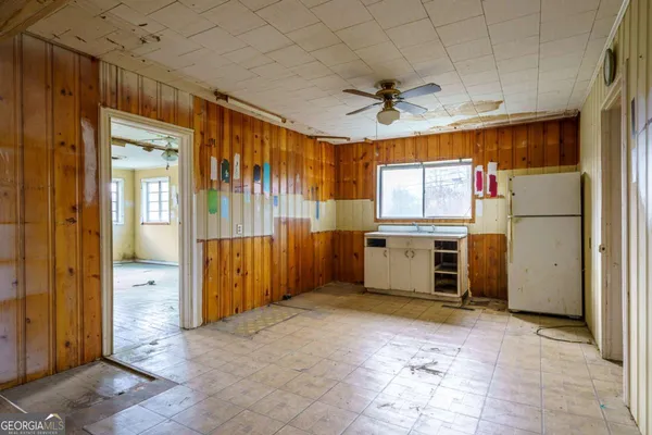 a view of an empty room with a fireplace and a window