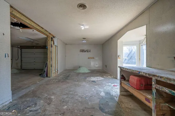 a room with a chair and white walls