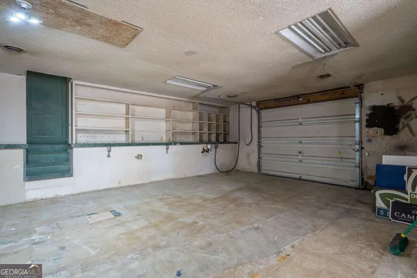 a view of a room with a furniture and a garage