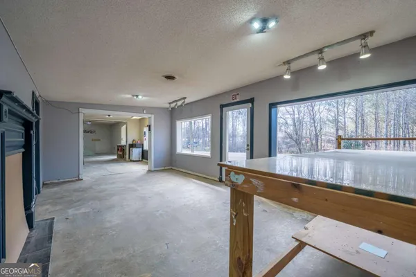 a view of a livingroom with a ceiling fan and window