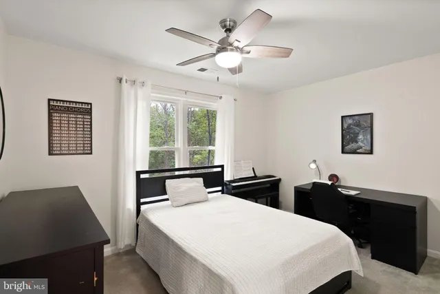 a bedroom with a bed and a desk