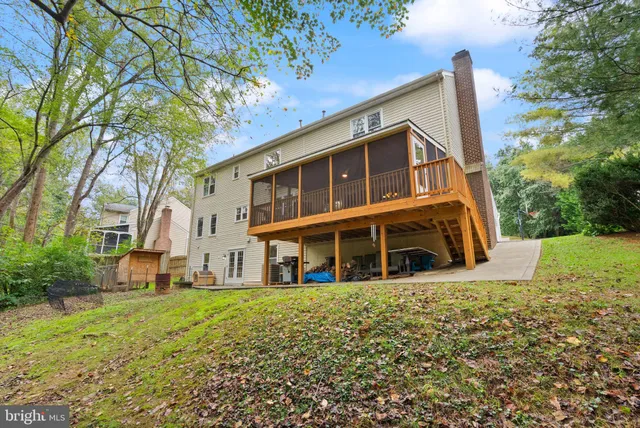 a view of a patio with table and chairs potted plants with wooden floor and fence