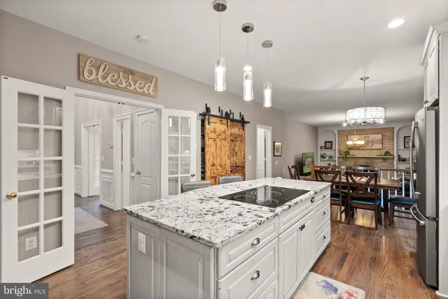 a kitchen with center island table and chairs
