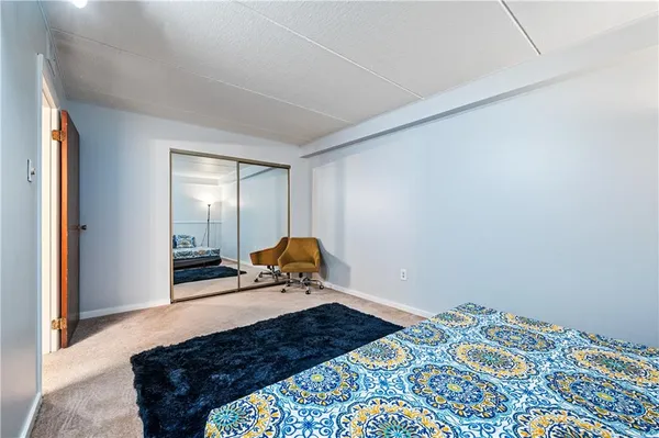 a bathroom with a granite countertop sink a toilet and a mirror