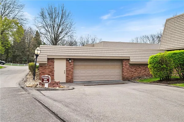 a view of a house with a yard and garage
