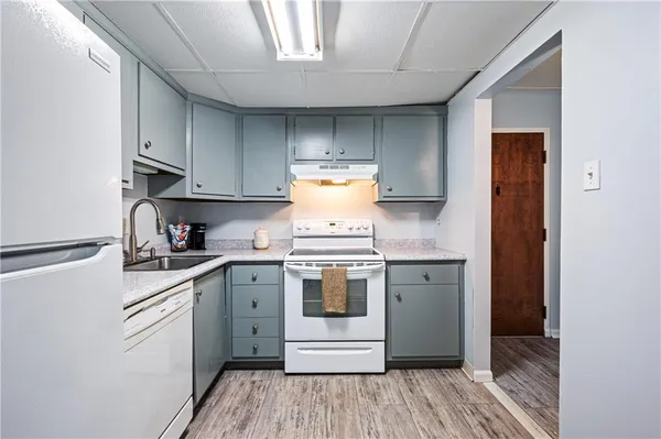a kitchen with cabinets appliances and a sink