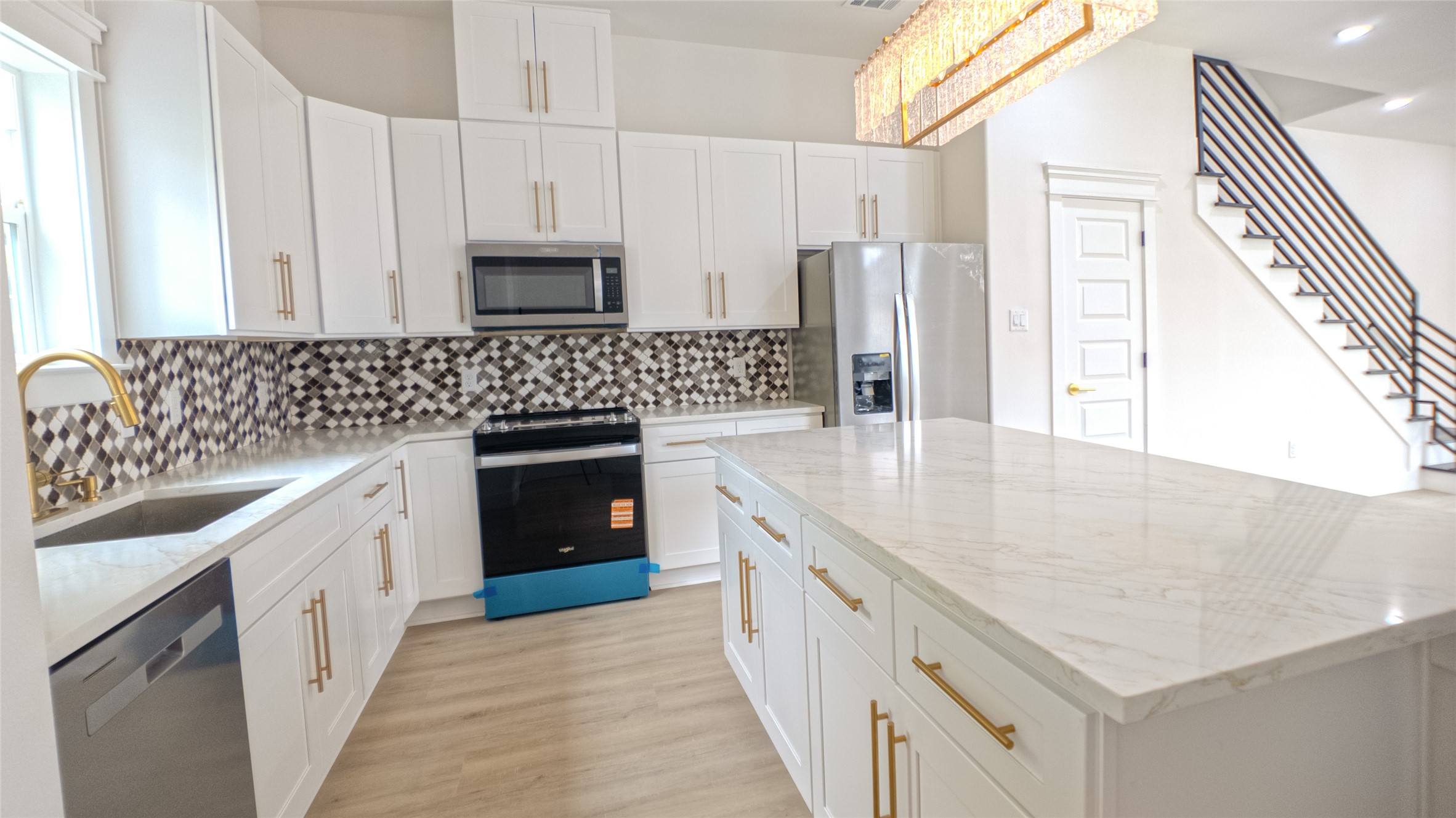 823 North Loop Houston, TX 77022 - Photo 7 of 23 a kitchen with stainless steel appliances granite countertop a sink stove and refrigerator