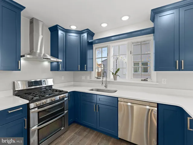 a large kitchen with stainless steel appliances kitchen island granite countertop a large counter top and sink