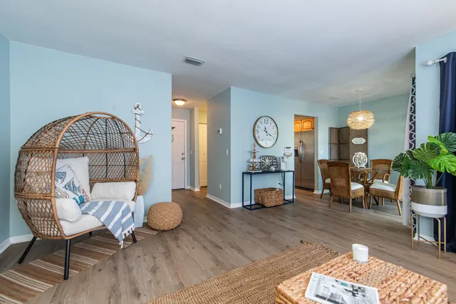 a view of a livingroom with furniture and a potted plant