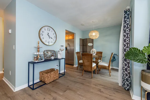a view of a dining room with furniture and wooden floor