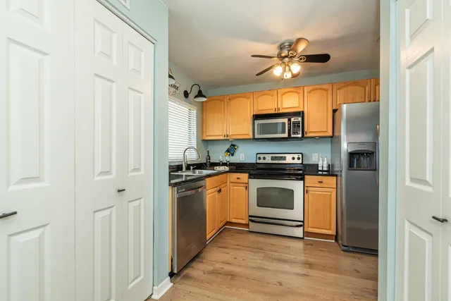 a kitchen with a stove cabinets and a microwave