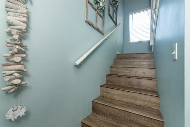 a bedroom with a bed and a table in it with wooden floor