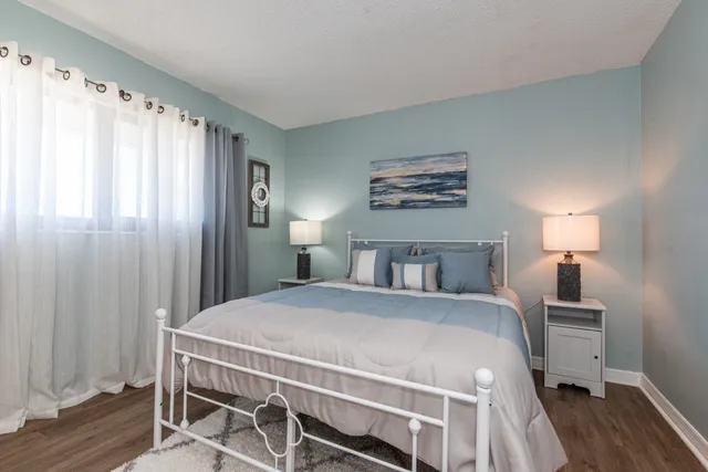 a bedroom with a bed and a lamp