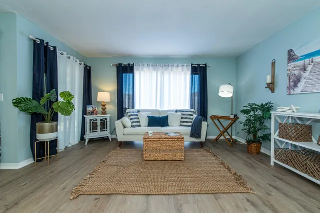 a living room with furniture and a potted plant
