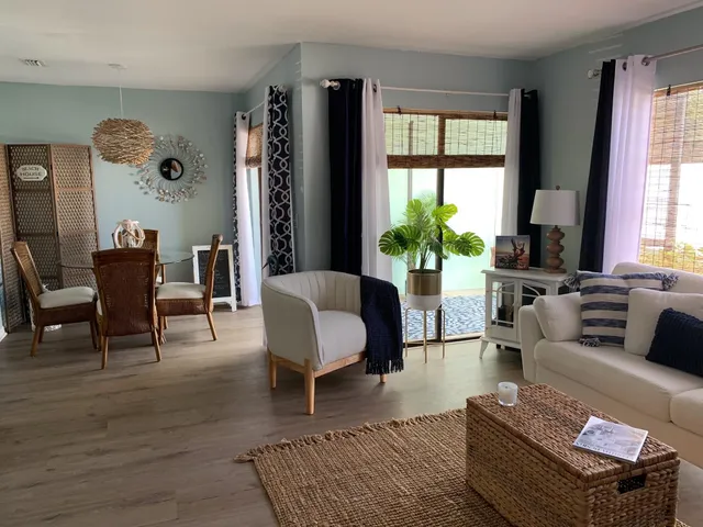 a living room with furniture large window and a table