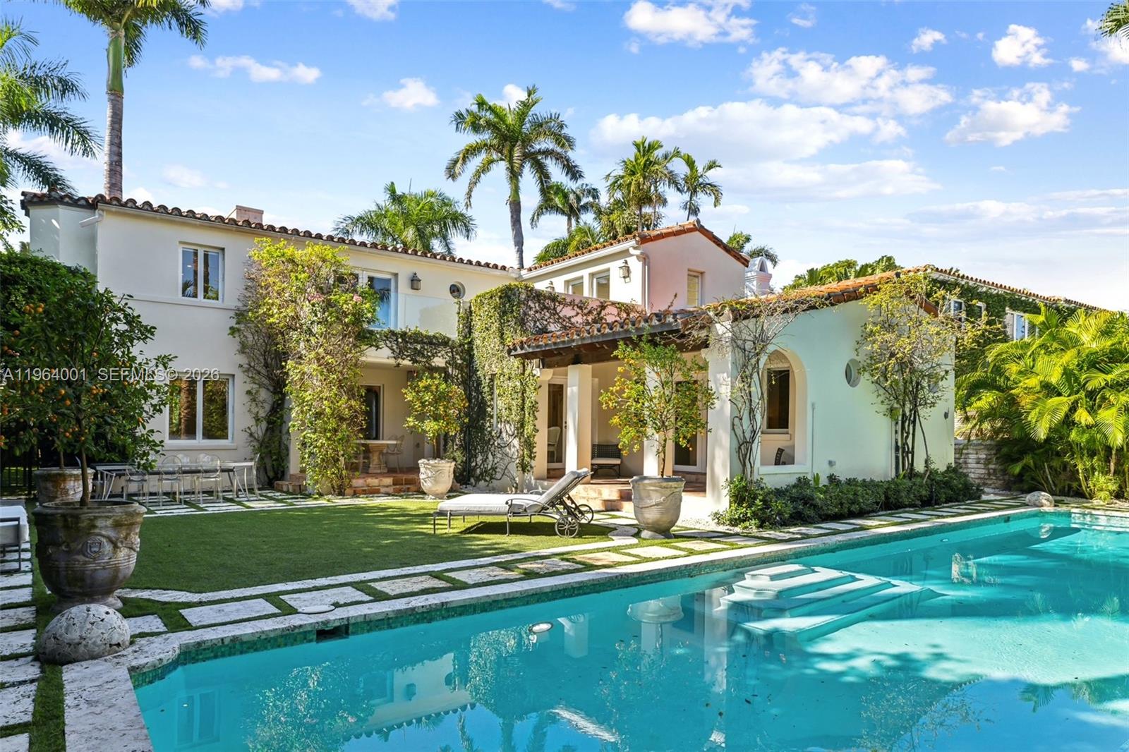 5711 North Bay Road Miami Beach, FL 33140 - Photo 2 of 14 a front view of a house with swimming pool and garden