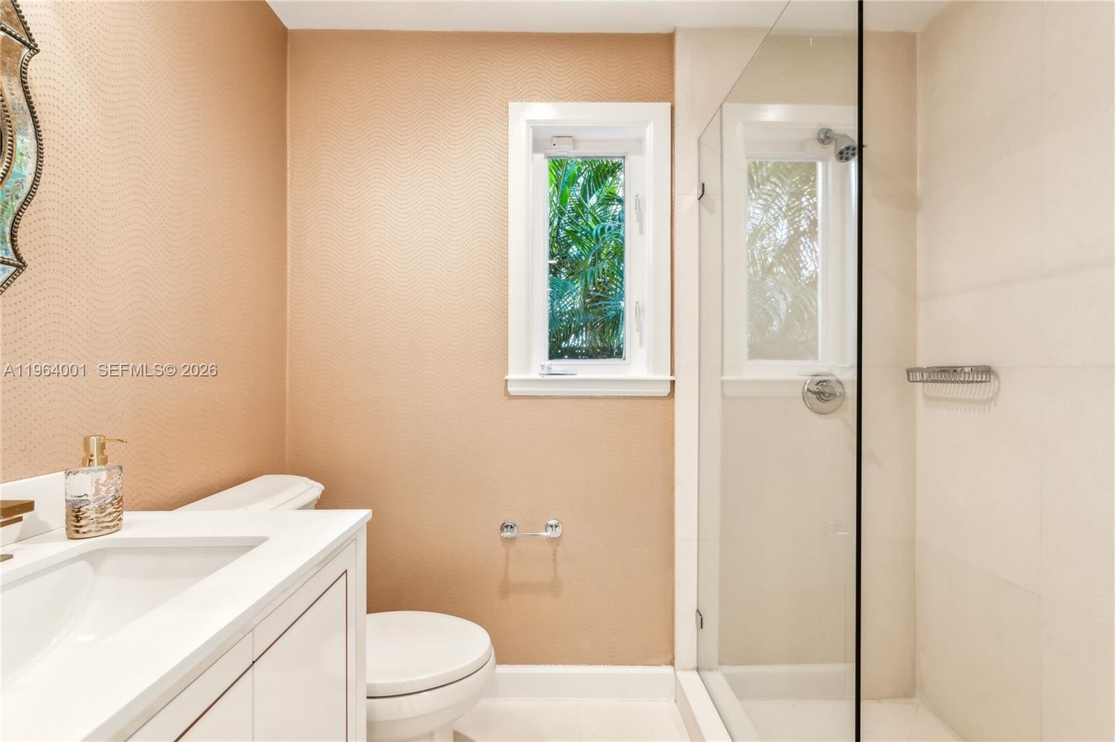 5711 North Bay Road Miami Beach, FL 33140 - Photo 6 of 14 a bathroom with a sink a toilet and shower