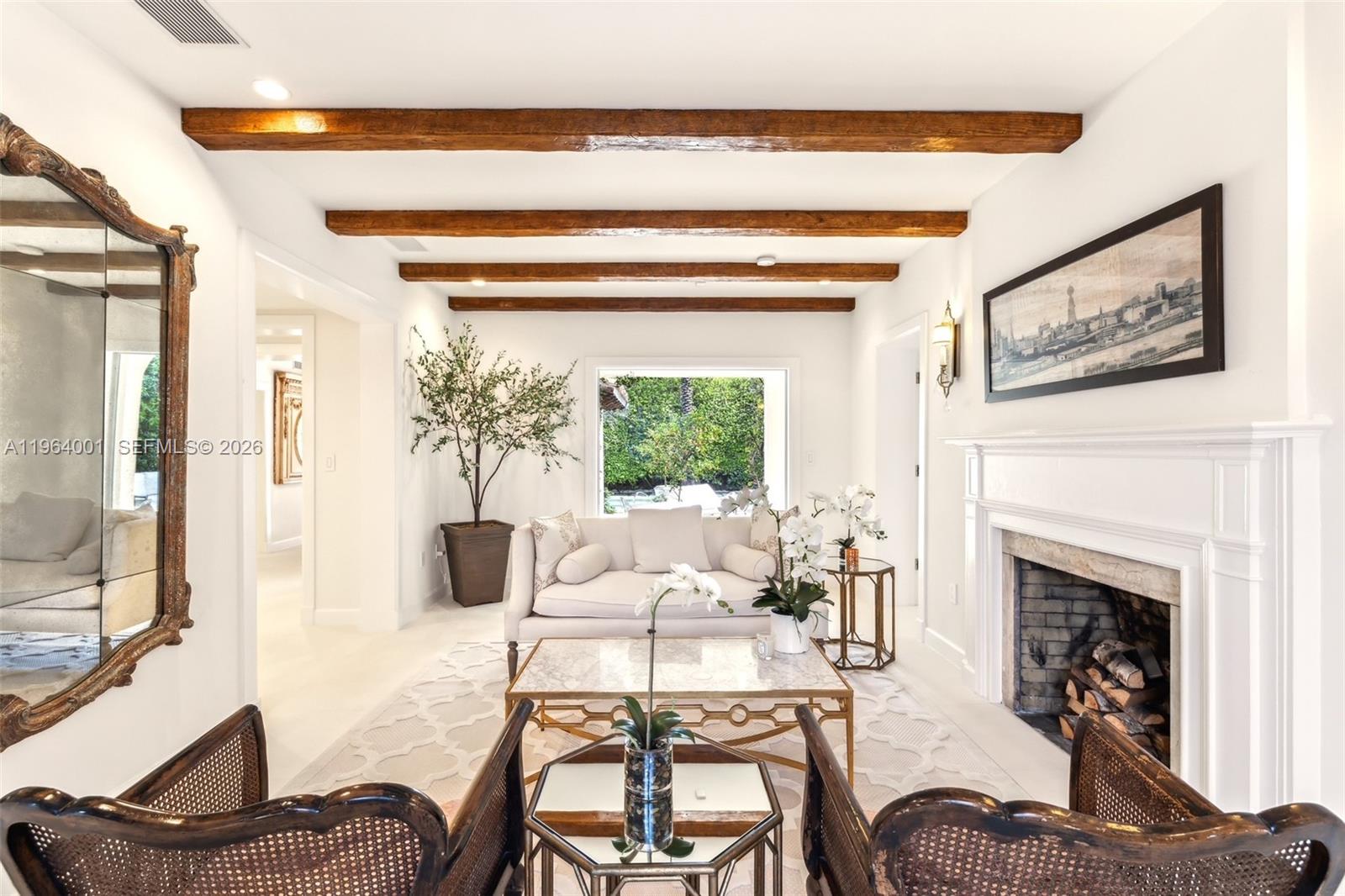 5711 North Bay Road Miami Beach, FL 33140 - Photo 7 of 14 a living room with furniture and a fireplace