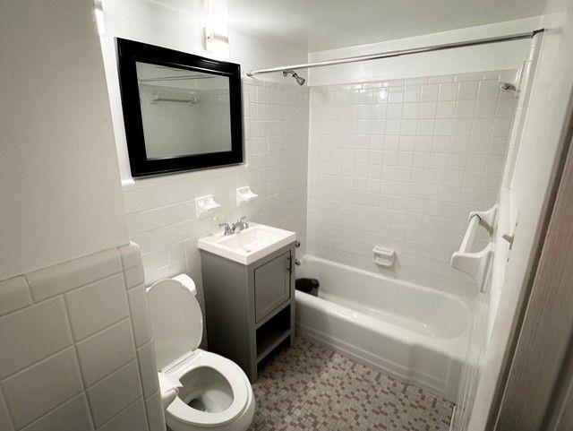 3510 Roswell Road Northwest, Unit J3 Atlanta, GA 30305 - Photo 10 of 17 a bathroom with a toilet sink and mirror or bathtub