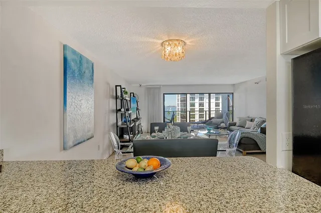 a kitchen with stainless steel appliances granite countertop a sink a stove cabinets and a microwave